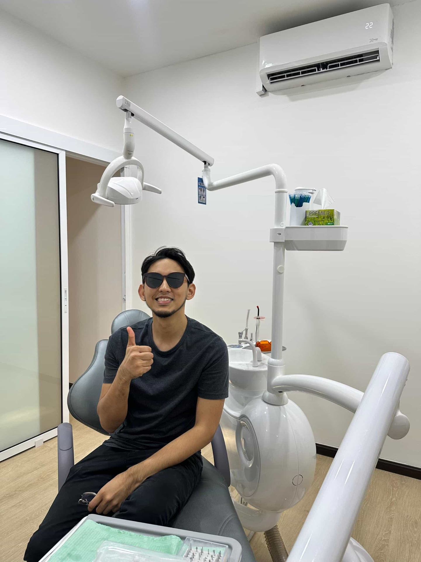 Patient smiling in the treatment room after dental care