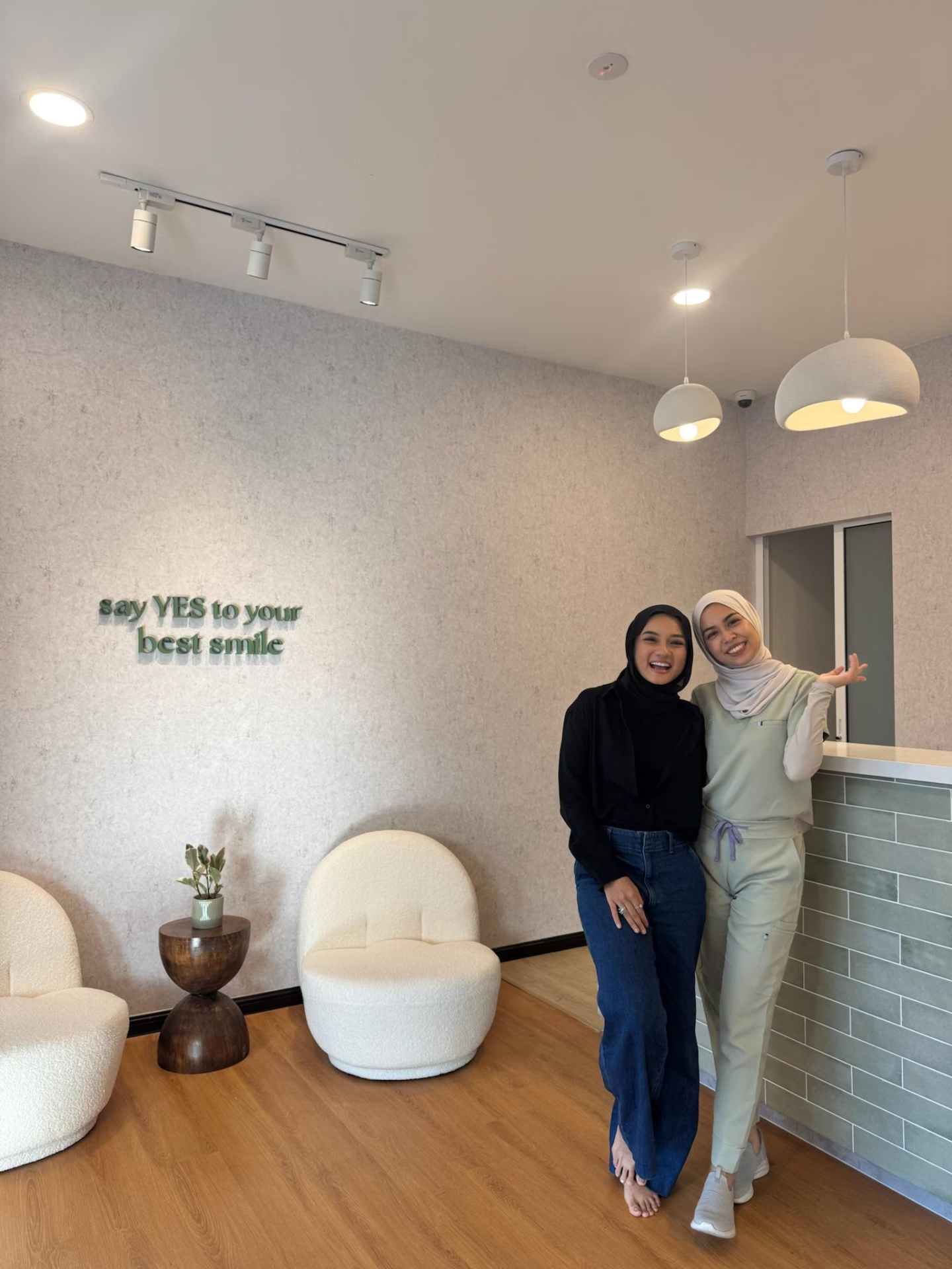 Guests smiling together in the YES Dental reception area