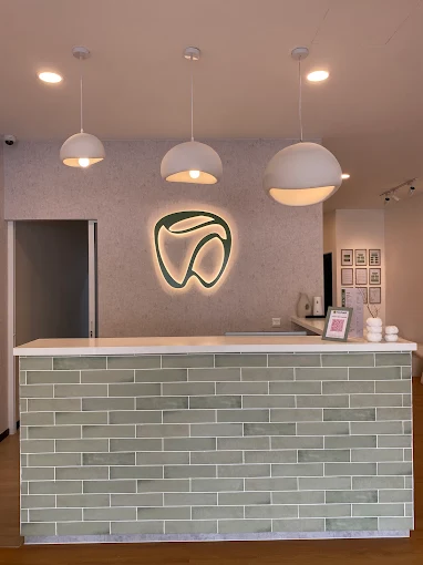 YES Dental front desk with illuminated tooth logo