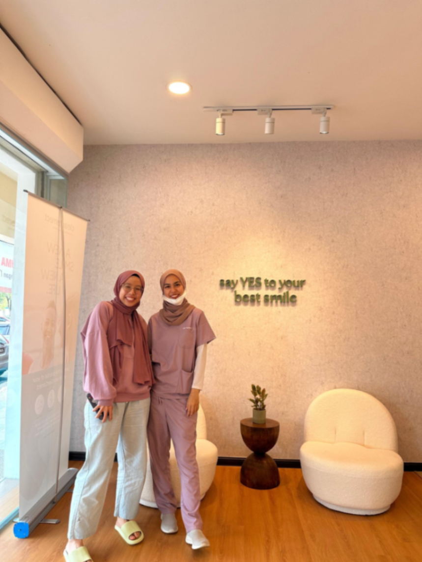 Patient and YES Dental staff posing in the clinic lobby